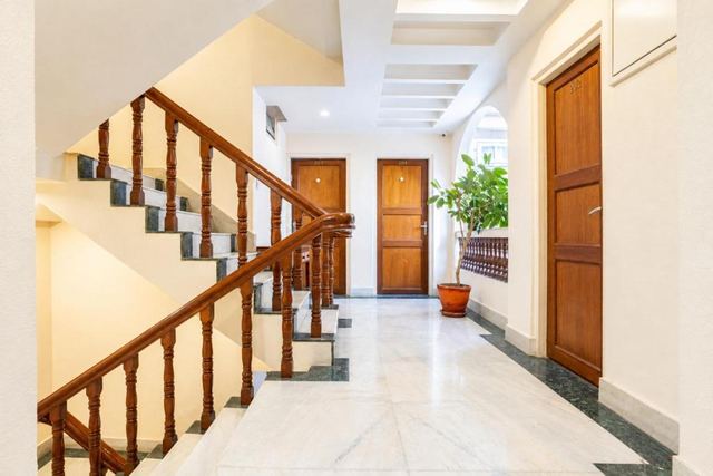 Marble corridor with a carved wooden staircase railing