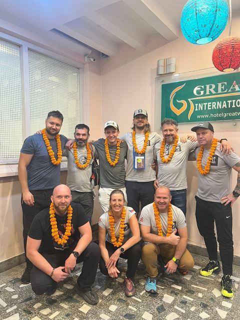 A trekking team wearing marigold garlands in the lobby