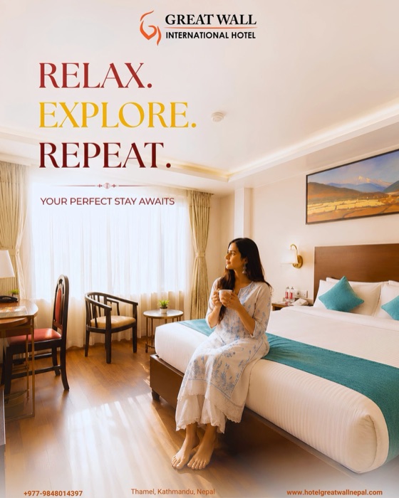 A guest with a cup of tea, relaxing on the bed in a bright Greatwall room